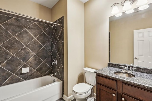 full bathroom featuring toilet, vanity, and tiled shower / bath