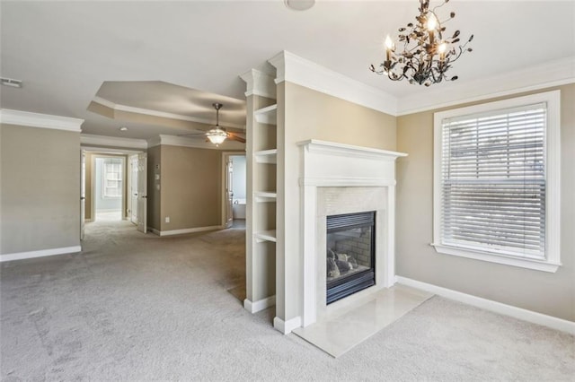 unfurnished living room with light carpet, ceiling fan with notable chandelier, and crown molding