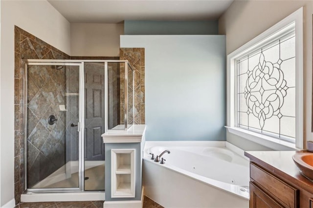 bathroom with vanity and independent shower and bath