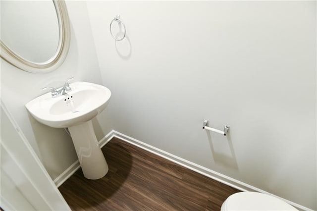 bathroom featuring toilet and hardwood / wood-style flooring