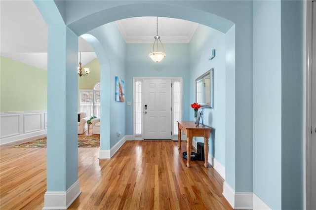 604 Greenleaf Way, Ball Ground, GA 30107 - entryway with wood finished floors, arched walkways, and crown molding