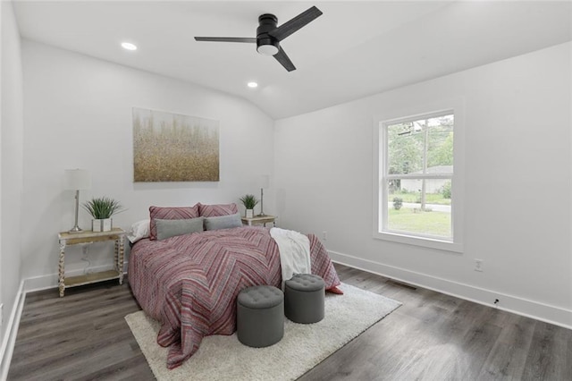 bedroom with ceiling fan, dark wood-type flooring, and vaulted ceiling