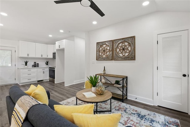 living room with dark hardwood / wood-style floors, ceiling fan, and lofted ceiling