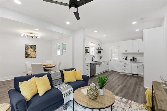 living room featuring lofted ceiling, ceiling fan, sink, and dark hardwood / wood-style floors