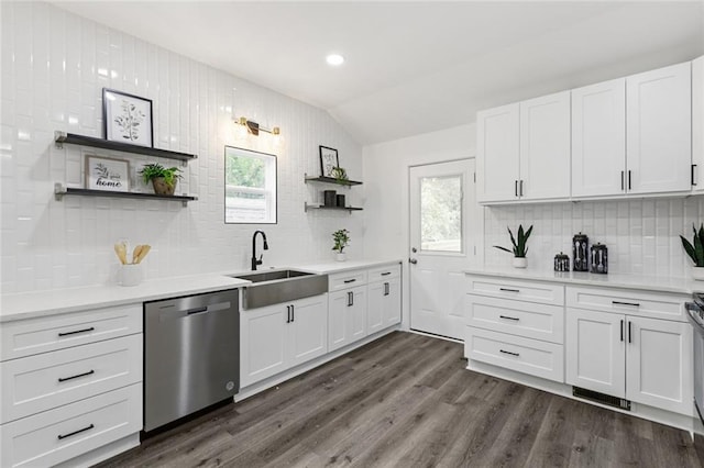 kitchen featuring white cabinetry, dishwasher, sink, backsplash, and lofted ceiling