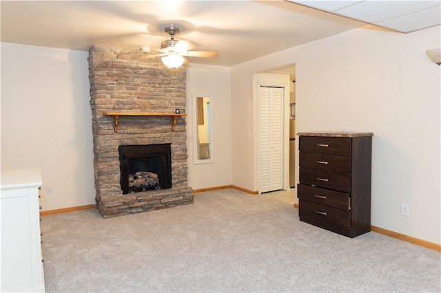 1043 Foxhollow Trl, Canton, GA 30115 - unfurnished living room featuring a ceiling fan, carpet, a stone fireplace, and baseboards