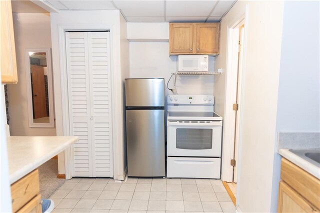 1043 Foxhollow Trl, Canton, GA 30115 - kitchen featuring white appliances, light tile patterned floors, light countertops, light brown cabinetry, and a drop ceiling