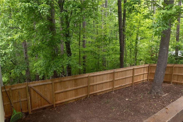 1043 Foxhollow Trl, Canton, GA 30115 - view of yard with fence and a forest view
