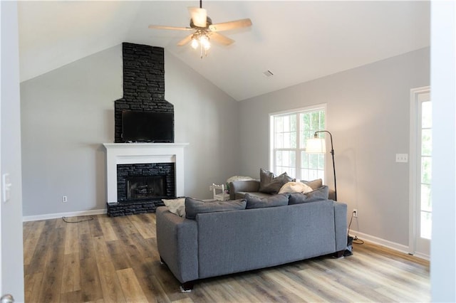 1043 Foxhollow Trl, Canton, GA 30115 - living area featuring a ceiling fan, vaulted ceiling, a stone fireplace, wood finished floors, and baseboards