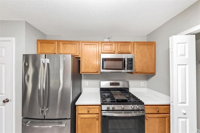 kitchen with stainless steel appliances and a textured ceiling