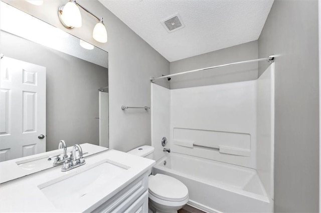 full bathroom featuring a textured ceiling, toilet, vanity, and shower / tub combination