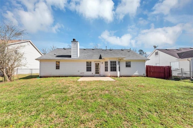 rear view of house featuring a patio and a lawn