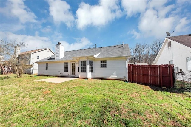 back of property featuring a yard and a patio area