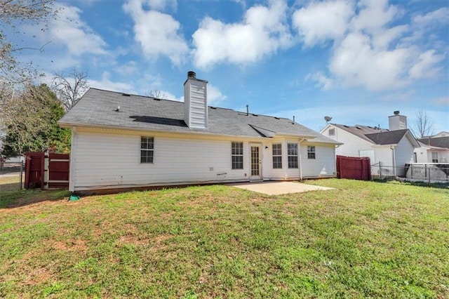 rear view of house featuring a patio and a yard