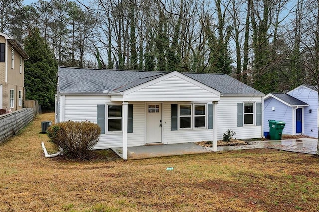 single story home with fence, central AC unit, a front yard, a patio area, and a shingled roof