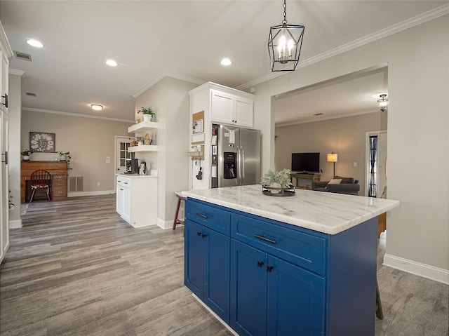 kitchen featuring visible vents, stainless steel refrigerator with ice dispenser, blue cabinetry, white cabinetry, and light wood-style floors