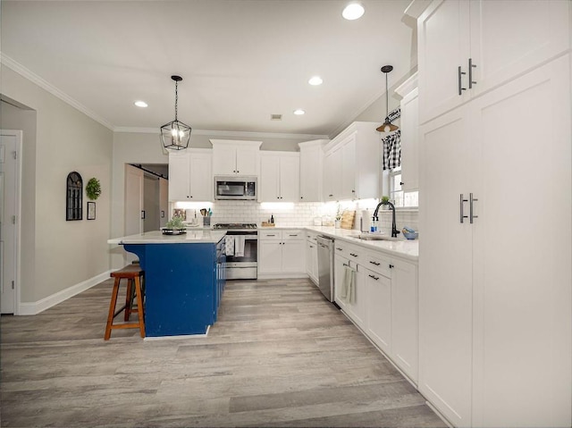 kitchen with a sink, crown molding, tasteful backsplash, and stainless steel appliances