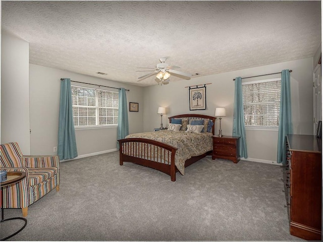 carpeted bedroom with ceiling fan, a textured ceiling, and baseboards