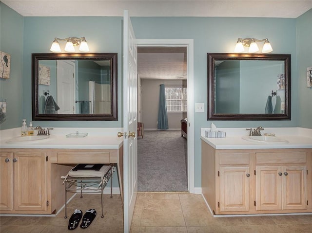 full bath featuring tile patterned floors, vanity, and baseboards