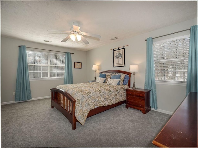 bedroom featuring visible vents, a textured ceiling, baseboards, and carpet