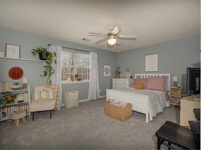 bedroom featuring a ceiling fan, baseboards, visible vents, carpet floors, and a textured ceiling