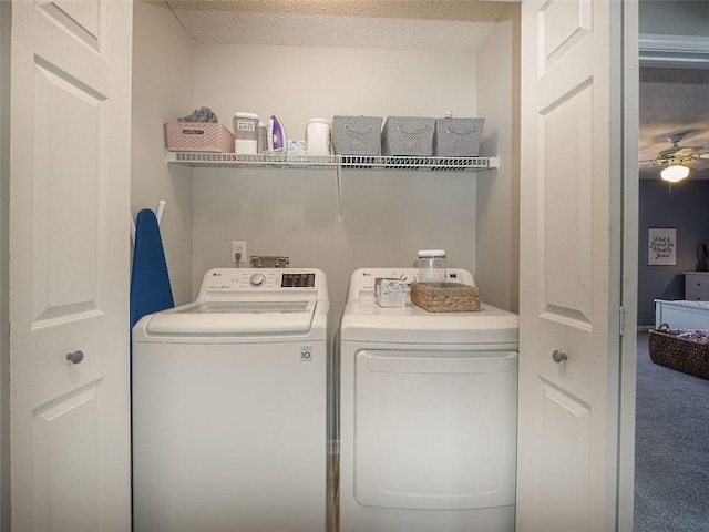 laundry room featuring washer and clothes dryer, a textured ceiling, carpet flooring, ceiling fan, and laundry area