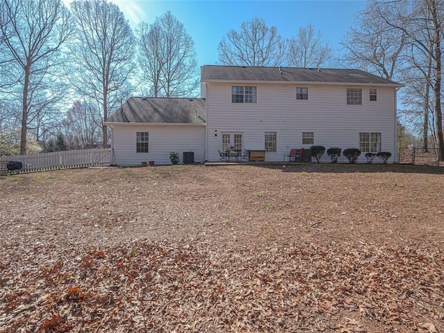 back of house featuring cooling unit and fence