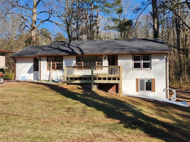 view of front facade with a wooden deck, a front lawn, and brick siding