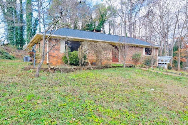 single story home featuring central air condition unit and a front lawn