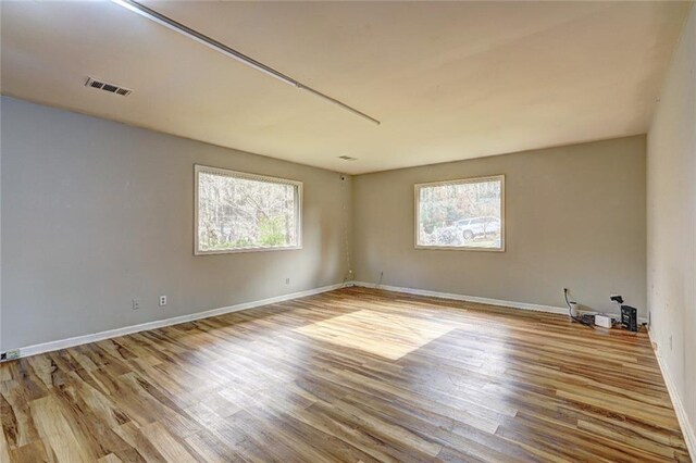 spare room with light hardwood / wood-style floors