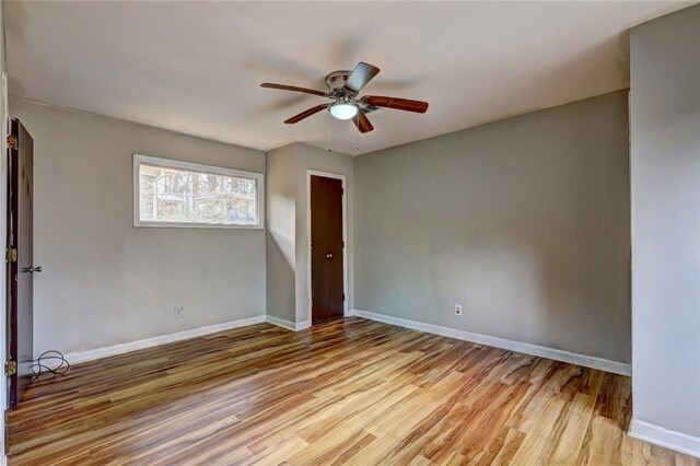 unfurnished bedroom with ceiling fan and light wood-type flooring