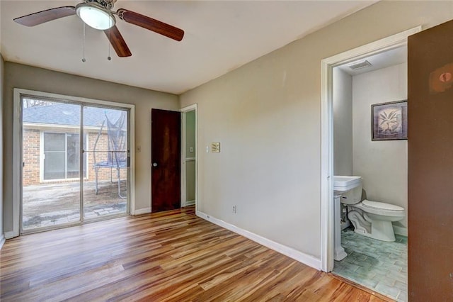 unfurnished bedroom featuring access to outside, ceiling fan, light hardwood / wood-style floors, and ensuite bathroom