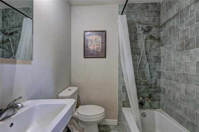 full bathroom with toilet, shower / bathtub combination with curtain, and sink