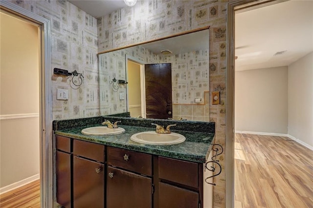 bathroom with hardwood / wood-style floors and vanity