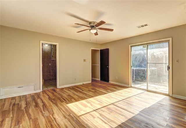 unfurnished bedroom featuring ceiling fan, light hardwood / wood-style floors, and access to exterior