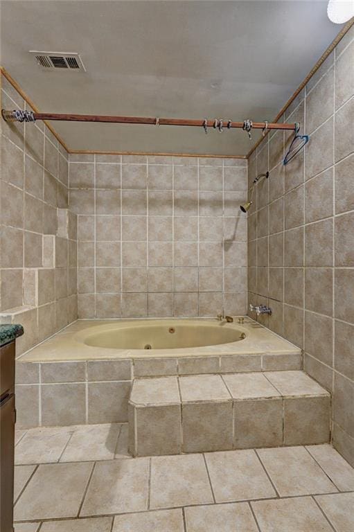 bathroom with vanity and tiled shower / bath combo