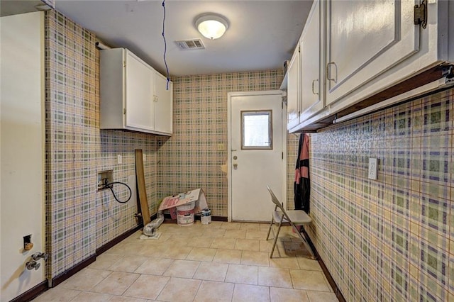 laundry room with cabinets, hookup for a washing machine, and light tile patterned floors