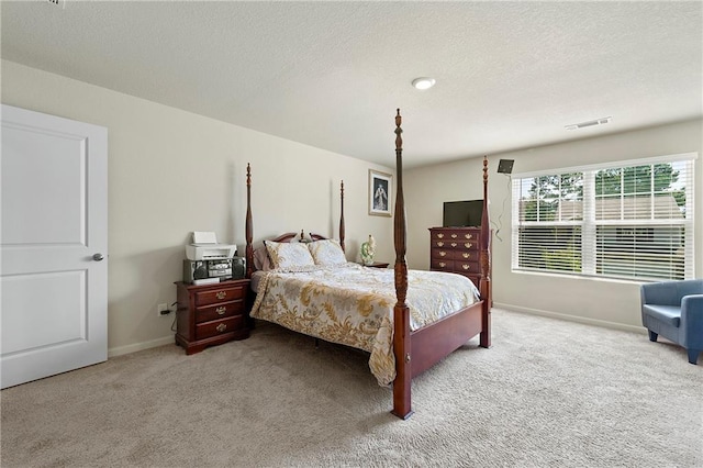 carpeted bedroom with a textured ceiling