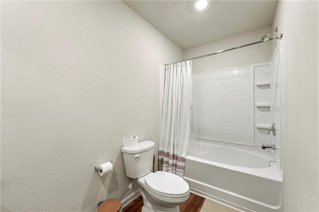 bathroom with toilet, shower / tub combo, and wood-type flooring