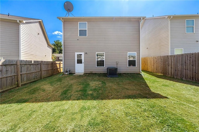 back of property featuring central AC unit and a lawn