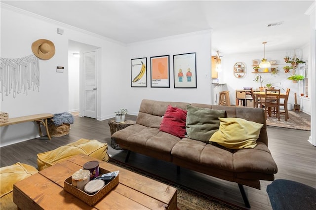 living room featuring ornamental molding and dark wood-type flooring