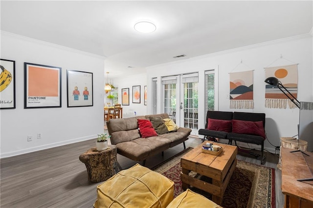 living room with french doors, dark hardwood / wood-style flooring, and crown molding