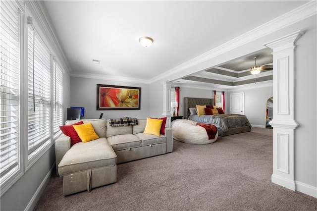 carpeted bedroom with ornamental molding, decorative columns, and a raised ceiling