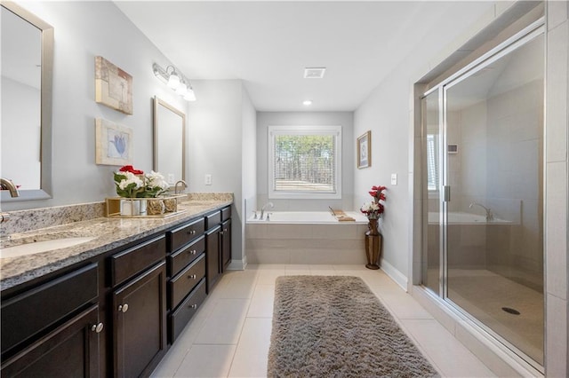 bathroom featuring tile patterned flooring, vanity, and separate shower and tub