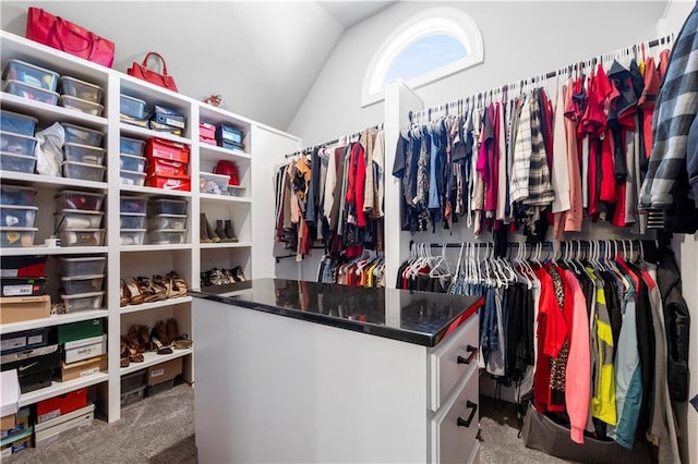 walk in closet featuring carpet floors and vaulted ceiling