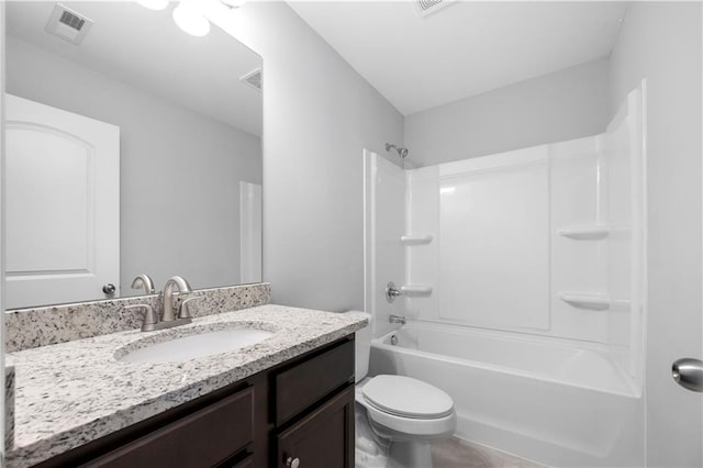 full bathroom featuring washtub / shower combination, vanity, and toilet