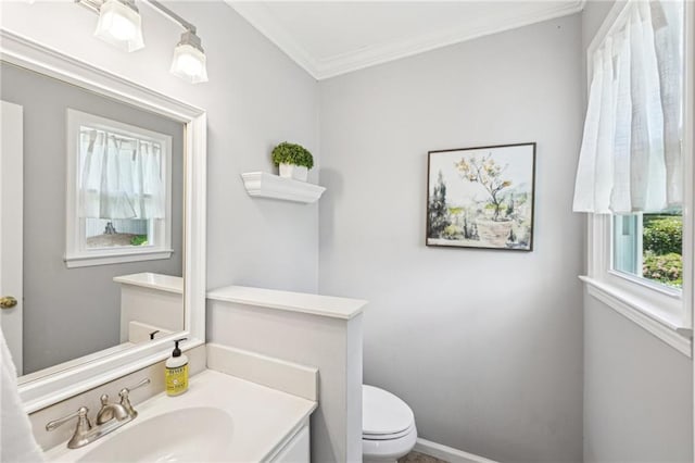 bathroom with ornamental molding, toilet, and vanity