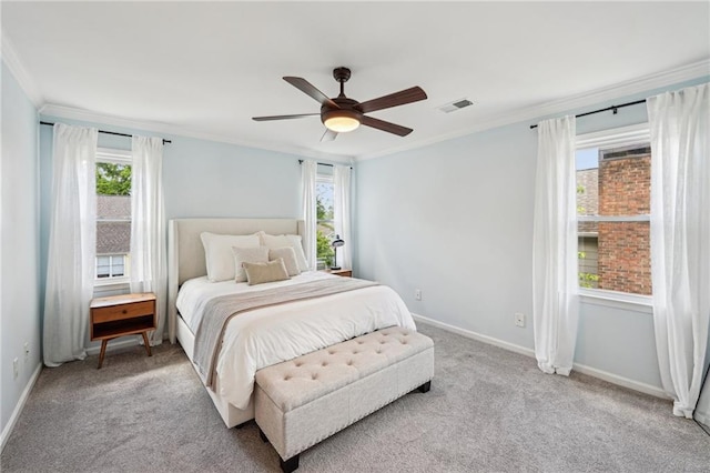bedroom featuring crown molding, light colored carpet, baseboards, and a ceiling fan