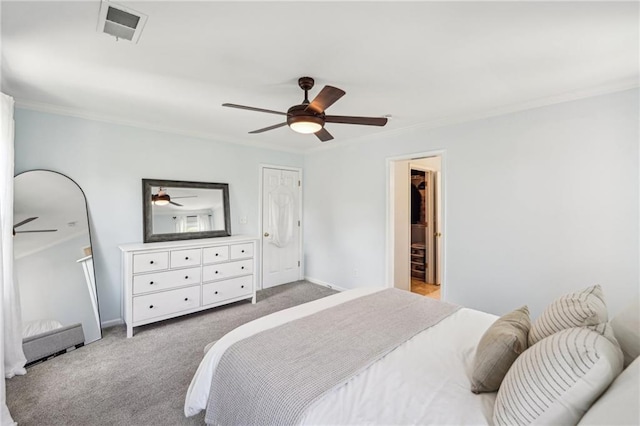 carpeted bedroom with crown molding, ceiling fan, and baseboards