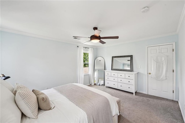 carpeted bedroom featuring ornamental molding, a ceiling fan, and baseboards